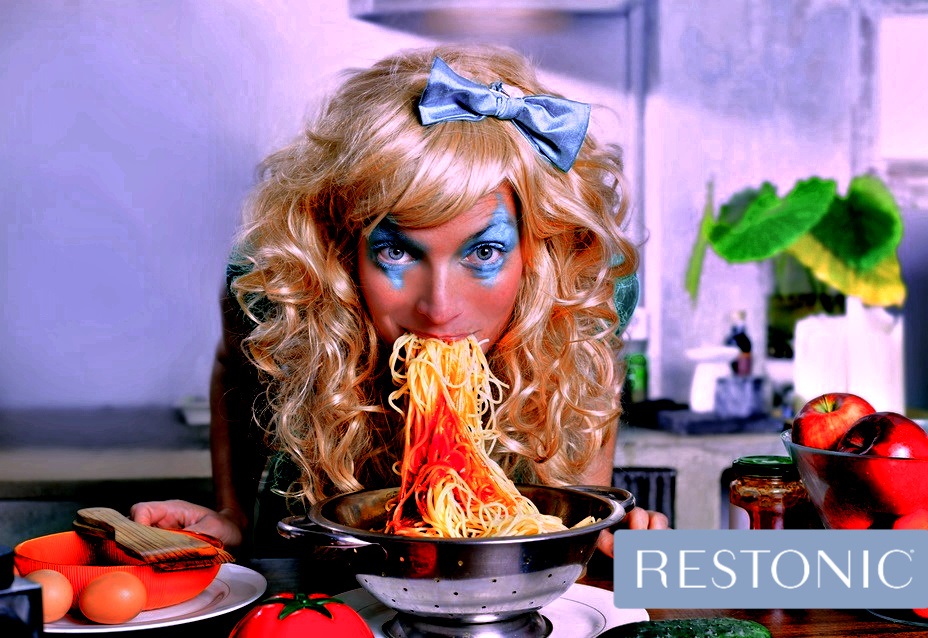 Woman eating spaghetti as if she is in your nightmare. Perhaps she just watched a horror movie?