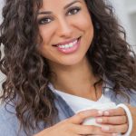 Woman posing with a coffee cup.